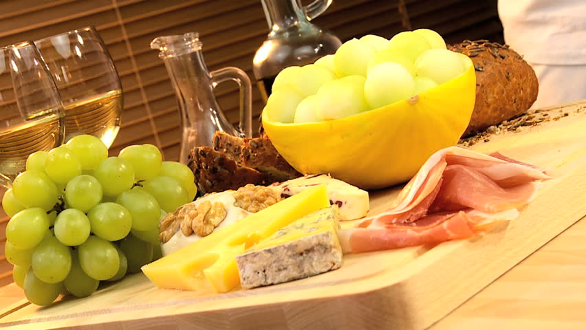 Delicious selection of cheese, oils, fruit & parma ham served with white wine
