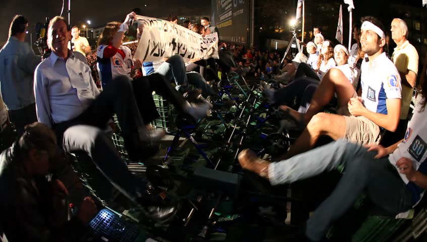 TEL AVIV, ISRAEL - APRIL 22: Earth Day commemoration 2010 takes place at Rabin Square. Mayor Ron Huldai (left) cycling to generate renewable electricity, Israel, Tel Aviv, April 22, 2010