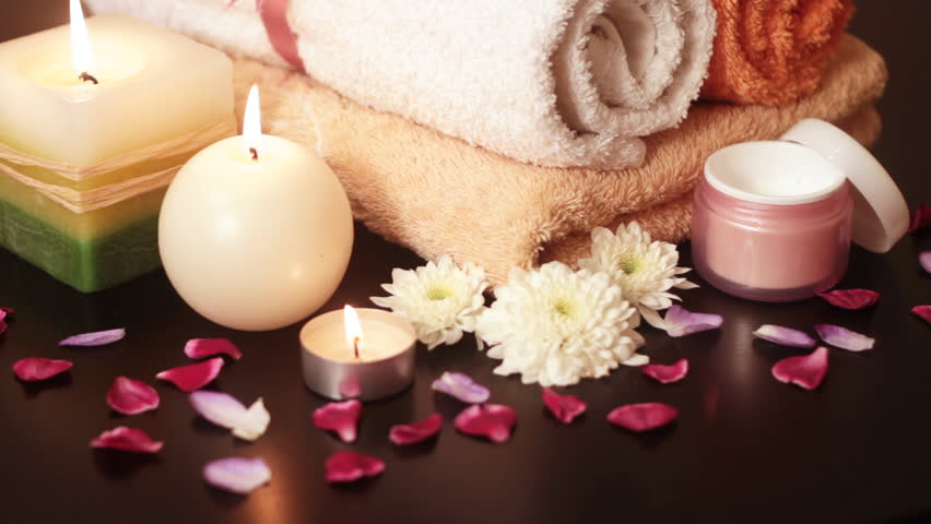 Spa accessories (moisturizer, candles, towels) at therapy center 