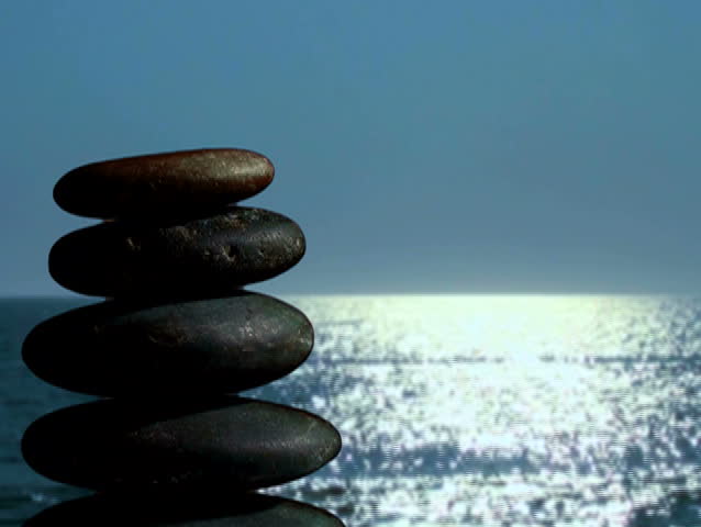 Massage stones against ocean waves in soft focus - NTSC