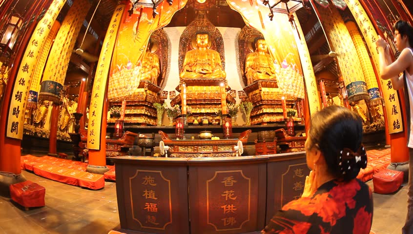 SHANGHAI, CHINA, - Buddhist visitors pray and light incense to practice their belief at Jade Buddha Temple (Yufo Si) - Shanghai, China, July 08, 2009