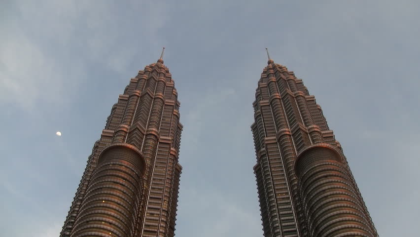 Timelapse of the Petronas towers in Kuala Lumpur Malaysia lightning up at dusk