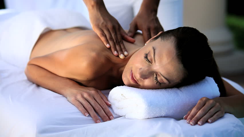 Sophisticated lady having massage treatment at a luxury health & beauty spa