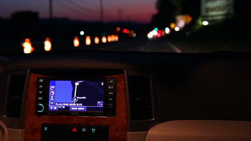 A man adjusts his in-dash GPS during a night drive. MAY BE SUITABLE FOR EDITORIAL USE ONLY.