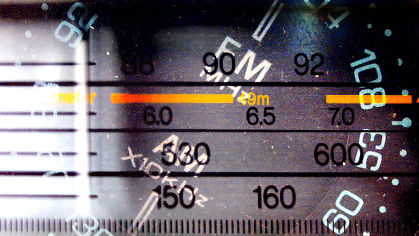 an analogue radio dial tuning in different radio frequencies