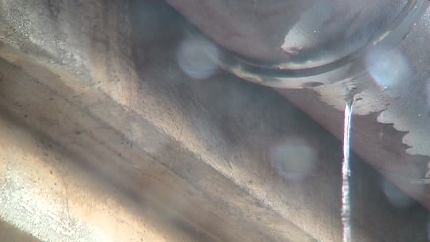 Waterdrops dripping from a roof