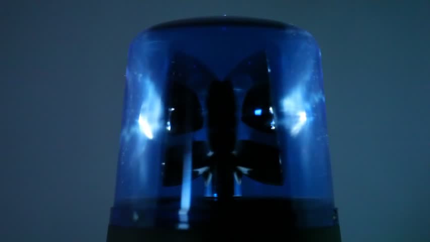 Blue flasher rotates rapidly in dark and  illuminates wall behind it with a bright light 