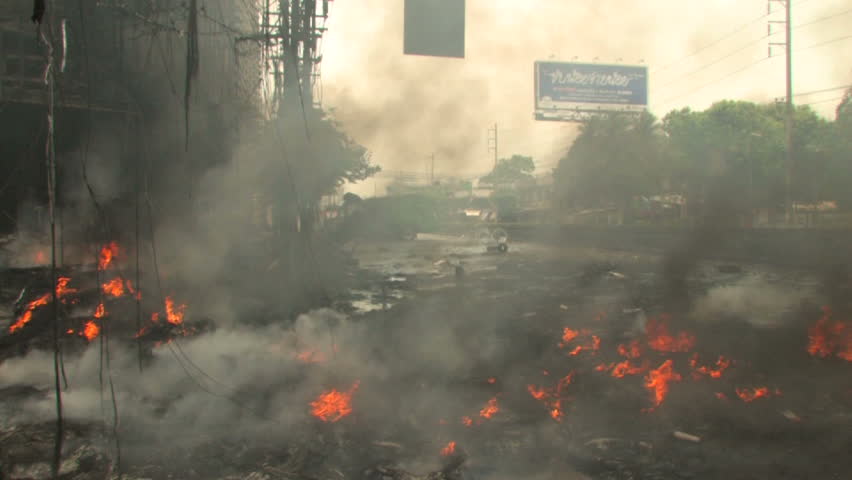 BANGKOK, THAILAND - April 19, 2010: Firemen battle blazes across the city after protesters set more than 40 buildings on fire during a government crackdown  
