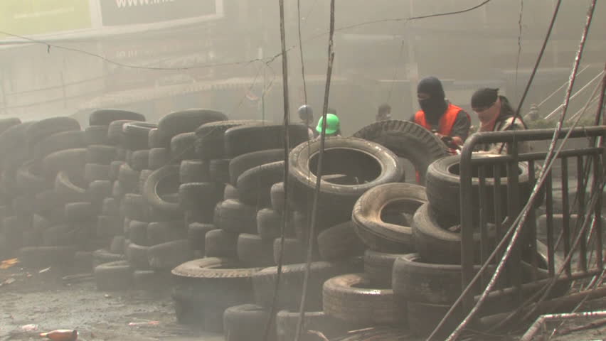 BANGKOK, THAILAND - April 19, 2010: Protesters build barricades built of tires to create smoke screens seeking protection from government snipers