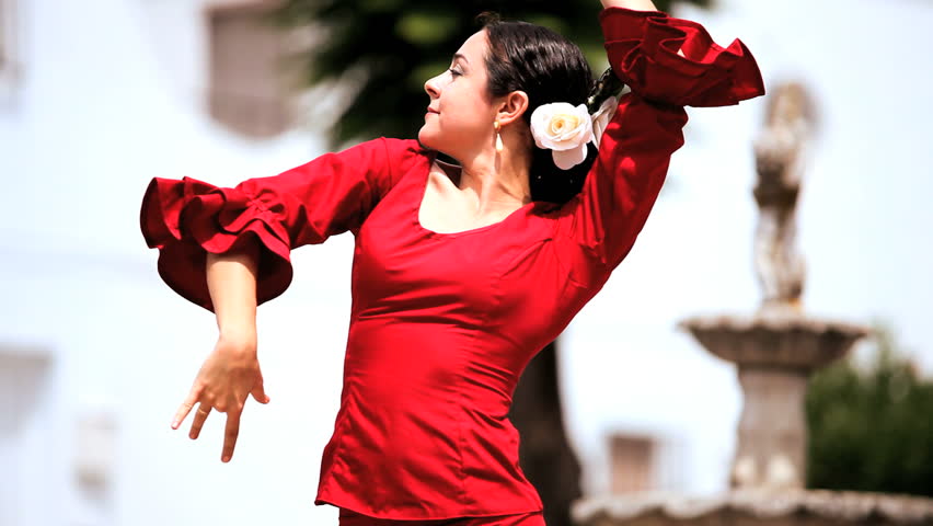 Beautiful lady dancing traditional spanish flamenco in town square Seville