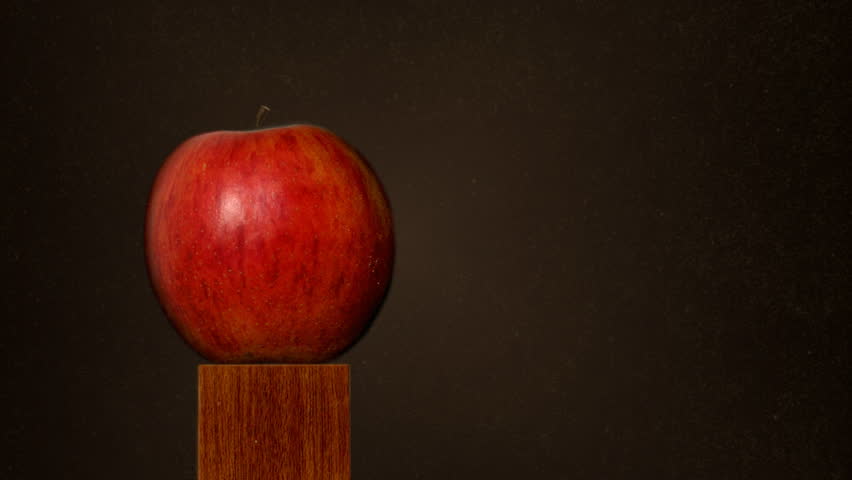 Missed target. Slow motion of a bullet aiming an apple and missing it. A limited amount of scratches and dust were added. 