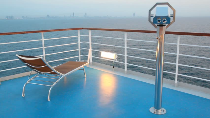 deck chair and stationary binocular on moving cruise ship