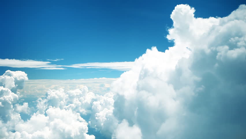 Abstract cloud shapes floating by. Natural movements of airplane causing shakiness of footage which is shot from plane window