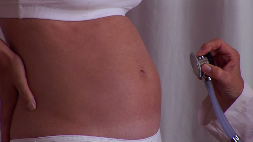 Pregnant woman posing with doctor and stethoscope 