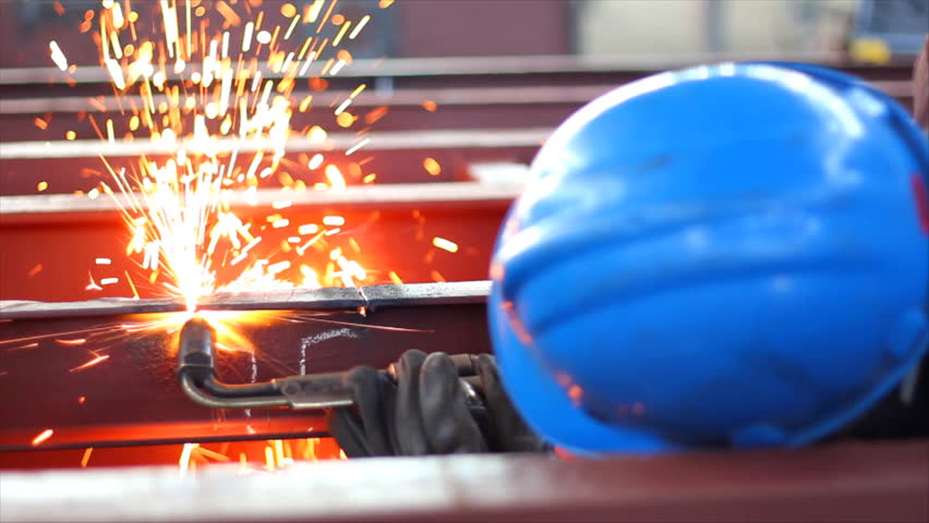 Worker cutting metal with a flame, slow motion
