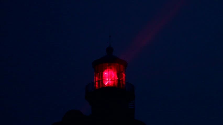 red lighthouse illuminated at night, ouessant island, brittany, france 