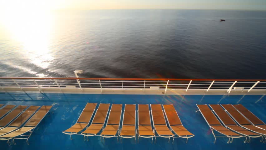 row of deckchairs on deck of cruise ship