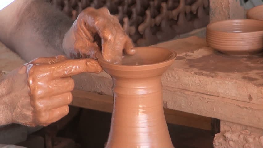 A potter making a clay cup