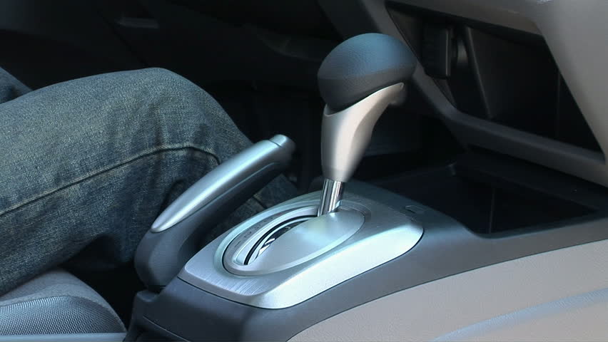 Man putting car into gear