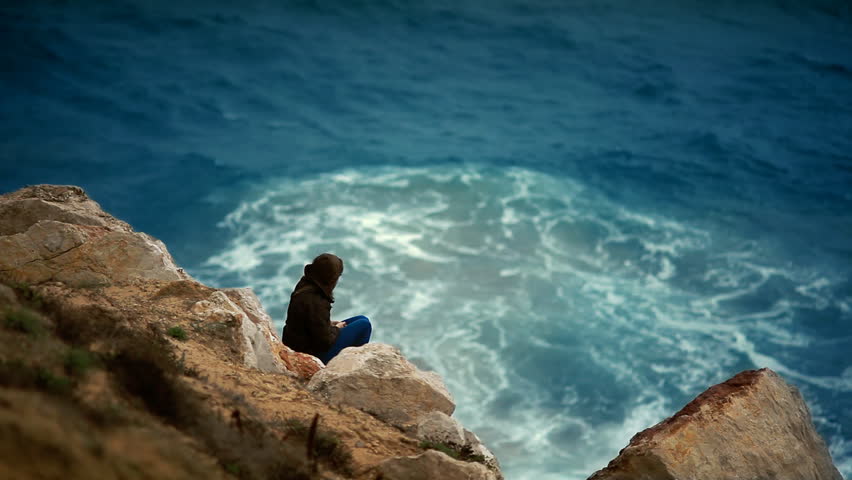 lady relaxing on the rocks winter