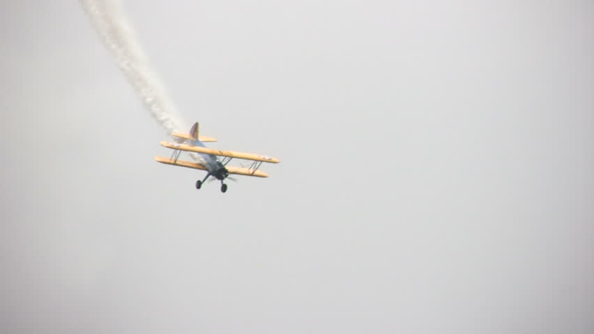 Old biplane performing stunt
