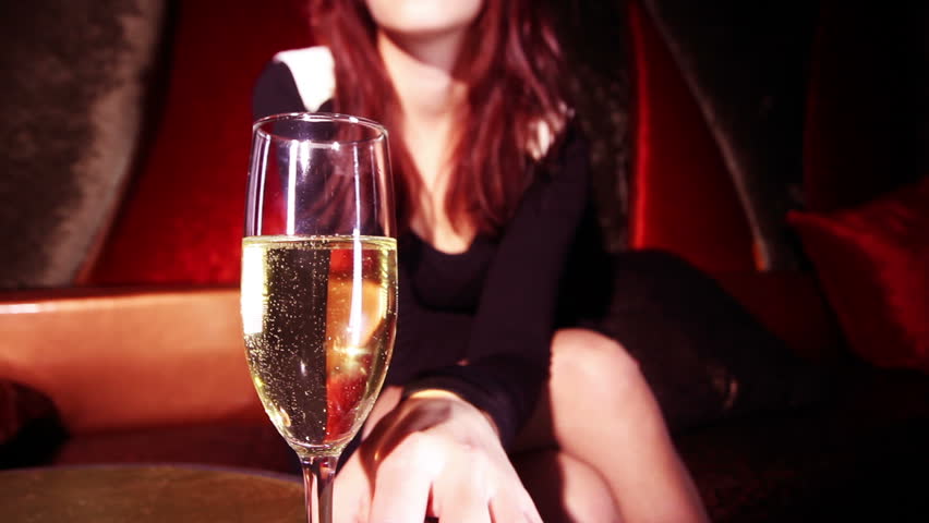 beautiful classic pinup girl in a VIP club drinking champagne