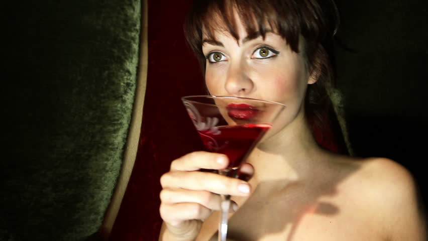 beautiful classic pinup girl in a VIP club drinking a cocktail