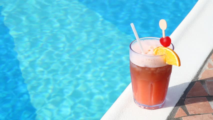 cocktail glass near water pool