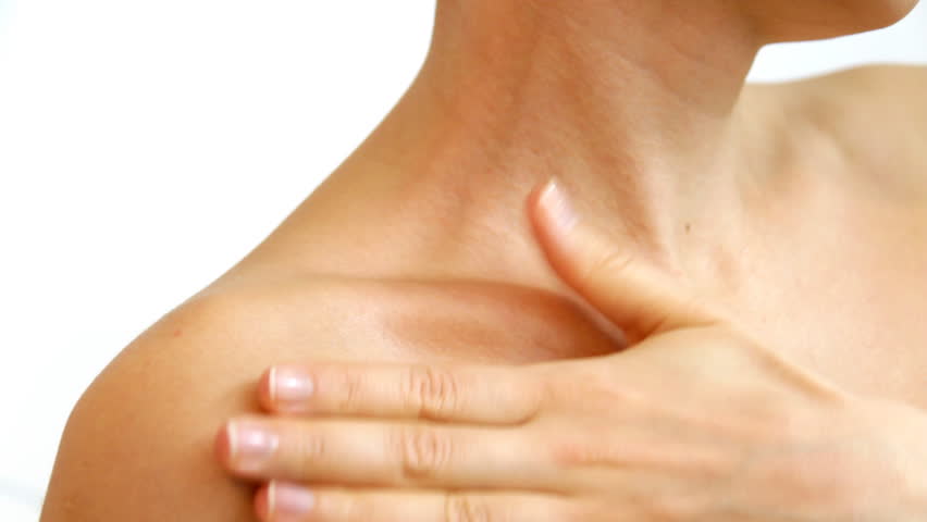 Woman gently touching her neck, isolated on white 