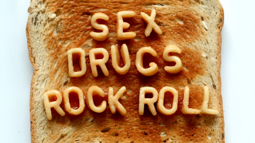 sex drugs rock n roll written with spaghetti pasta letters in tomato sauce on toast