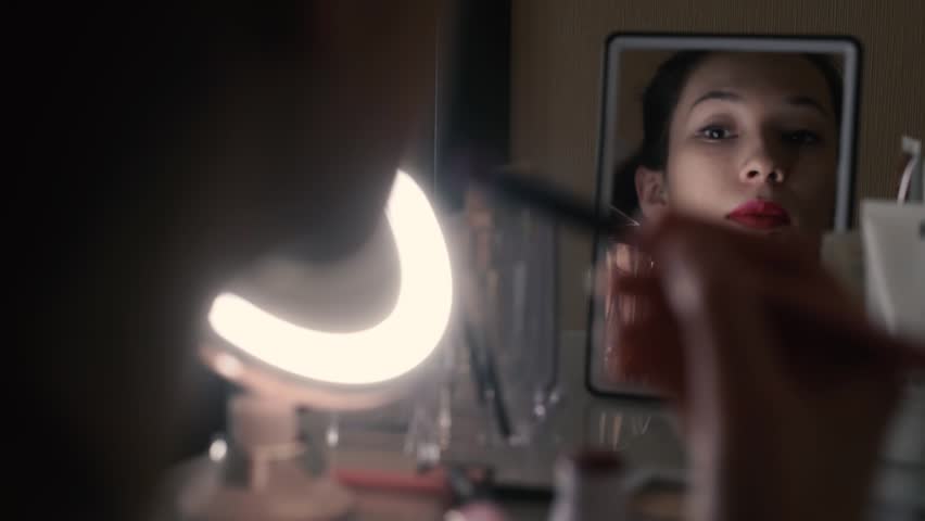 Woman Putting Red Lipstick Looking In Mirror Makeup At Night Getting Ready Before Going To Woman Putting Red Lipstick Looking In Mirror Makeup At Night Getting Ready Before Going To