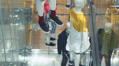 View through window to modern concept manikins at the store. Government manipulation concept.