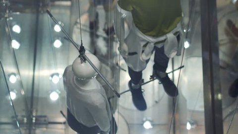 View through window to modern concept manikins at the store. Government manipulation concept.