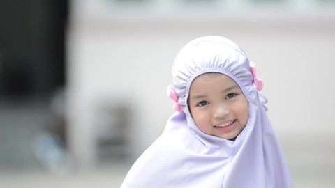 Muslim Schoolgirl Porn - Happy asian muslim little kid girl in hijab showing her perfect smile and  laughing. kid,daughter,sister,fun and child concept.