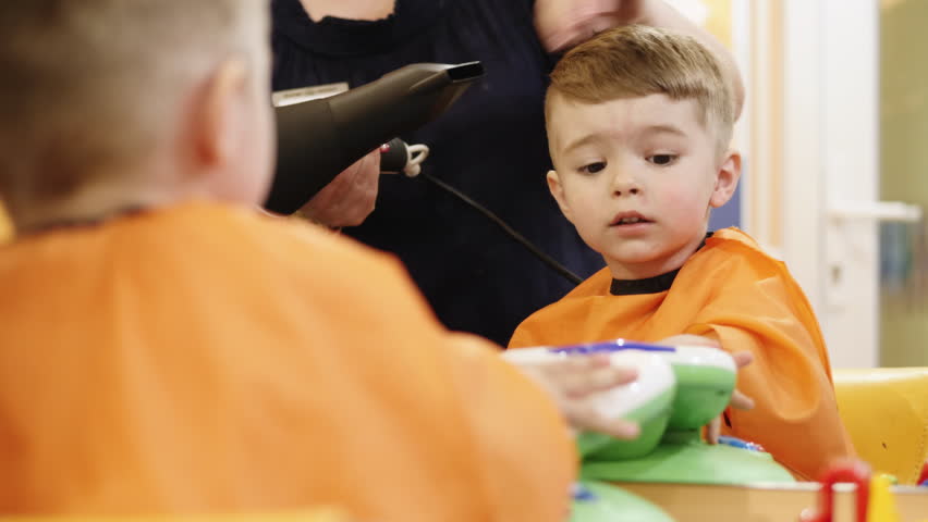 Child Hairstyle Hairdresser Working With Small Boy In Barbershop