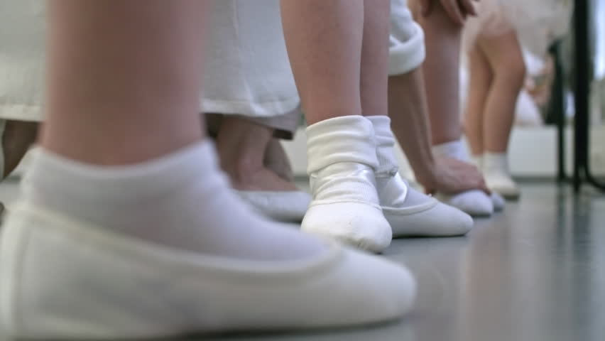 Close Up Feet Of Unrecognizable Little Girls In White Socks And Ballet