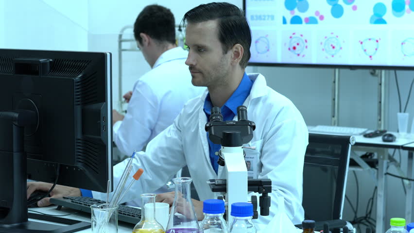 Scientific testing is. Мужчина перед современной лабораторией.