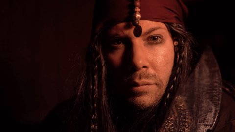 Portrait Of A Pirate Looking At Camera In Slow Motion Dark And Mysterious Portrait Of A Pirate Looking At Camera In Slow Motion Dark And Mysterious