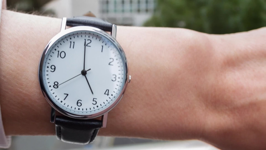 hd00:18Close up of a Caucasian man wearing a wrist watch ...