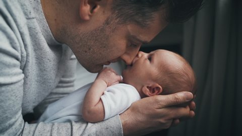 Tiny Model Candy Porn - Newborn baby snuggled close to father sucks on dad's nose while looking up  at him. dad holding a tiny infant in his hands. fatherhood concept with  daddy showing affection to baby.