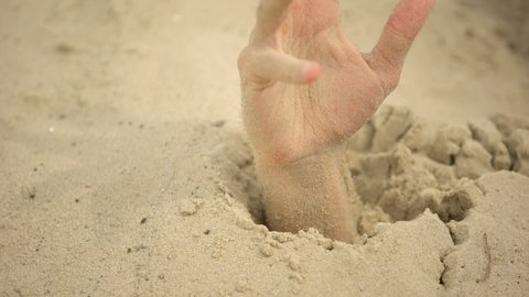 Male Hand Sinking In Puddle Of Quicksand Dangerous Travels In Desert Closeup