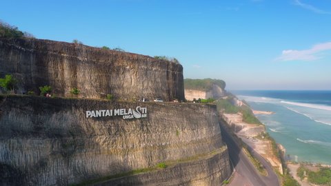 Melasti Beach Bali Indonesia Jun 8 2019 Melasti Beach Bali With Scenery Road Carved In Mountain Rock And Travel Tourist Taking Photo With Beautiful Retro Cars On Tropical Beach 4k Aerial View