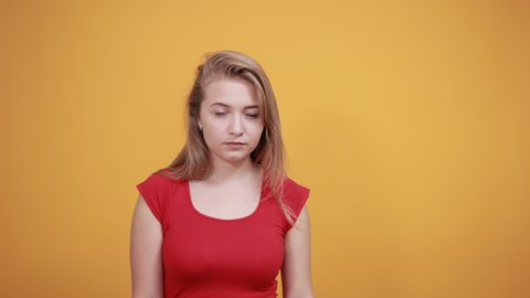 3d Lola Sex - Young blonde girl in red t-shirt over isolated orange background shows  emotions