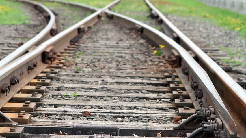 Close Up View Along Wooden Support Beams Of Rusted Railroad Tracks ...