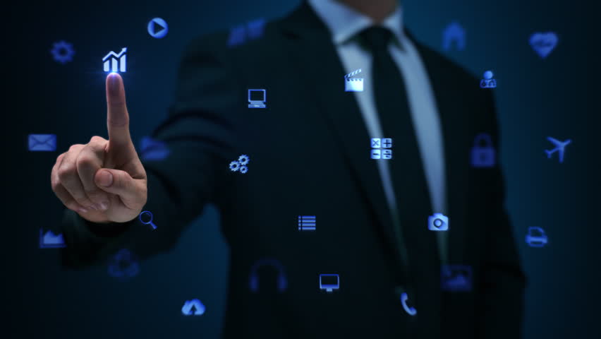 Businessman working on holographic interface. Financial. Blue. Man touching a visual screen with holographic computer icons. Financial diagrams appearing. More color options in my portfolio.