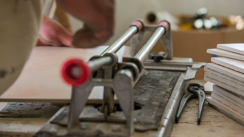 Person Cutting Ceramic Tiles Close Stock Footage 100 Royalty Person Cutting Ceramic Tiles Close Up Professional Tiler Using A Tool To Cut Many Right Size For Gluing On Floor Pile Of Beside