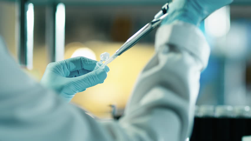 Close-up footage of a scientist using a micro pipette in a laboratory. Shot on RED Cinema Camera in 4K (UHD).