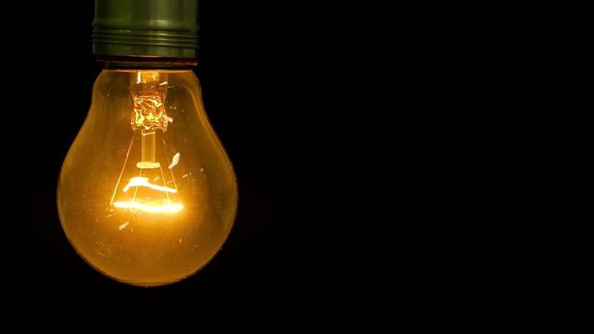 Close Up Of Glowing Element In The Incandescent Light Bulb, Showing Hot