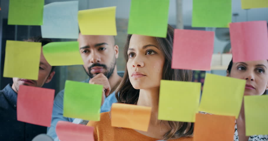 Creative business team brainstorming ideas working together sharing data late at night after hours in modern glass office
