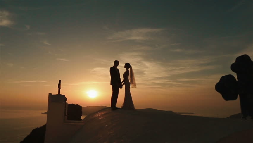 Happy Married Couple Walkiing Holding Hands On Church Roof At Sunset ...